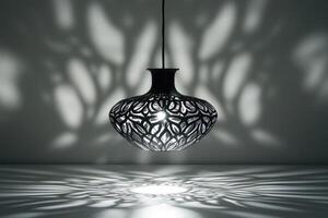 Black Hanging Lamp with Intricate Cutouts Casting Shadows photo