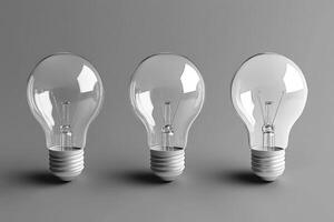Three Clear Incandescent Light Bulbs on a Gray Background photo