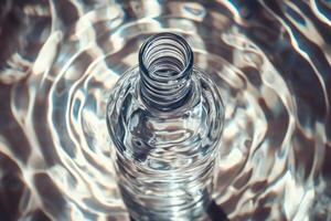 A Clear Glass Bottle Reflecting Water Ripples photo