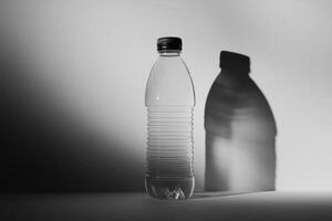 A Clear Plastic Water Bottle with Black Cap and a Shadow Cast on a White Background photo