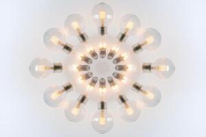 Circular Arrangement of Glowing Light Bulbs on a White Background photo