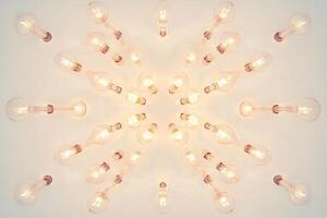 A Symmetrical Array of Glowing Light Bulbs on a White Ceiling photo
