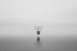 A Single Lightbulb Floating on a Calm Water Surface photo