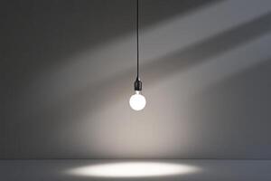 A Single Lightbulb Hanging from a Ceiling in a Room with a Grey Wall photo