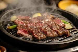 Sizzling Beef Steaks Grilling On A Hot Plate photo