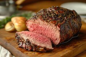 Roasted Beef Sliced On Wooden Board With Roasted Potatoes photo
