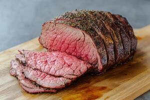 Sliced Roasted Beef on Wooden Cutting Board photo
