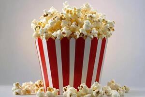 A Red Striped Bucket Filled With Buttery Popcorn photo