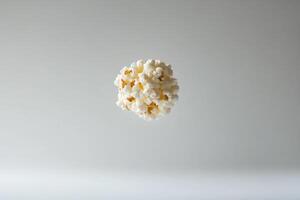 A spherical cluster of popcorn floats against a neutral background photo