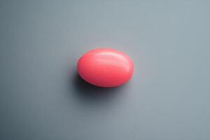 A Single Pink Sphere on a Gray Background photo