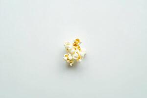 A Small Cluster Of Popcorn Kernels On White photo