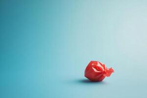 Red Candy Wrapper On A Blue Background photo