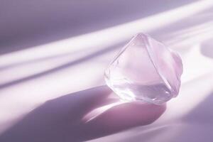 Translucent Crystal Resting on Lavender Fabric photo