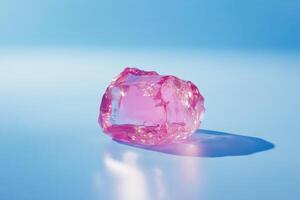 Pink Crystal Ice Cube on Blue Background photo