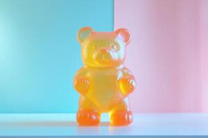 A translucent yellow gummy bear candy stands on a white surface photo