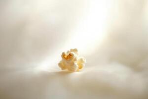 A Small Cluster Of Popcorn On A Soft Surface photo