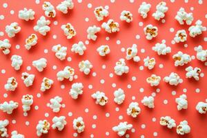 Popcorn Scattered On A Coral Polka Dot Background photo