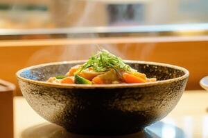 Steaming Bowl Of Savory Vegetable And Fish Stew photo