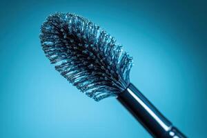 Closeup of a mascara wand with blue liquid photo