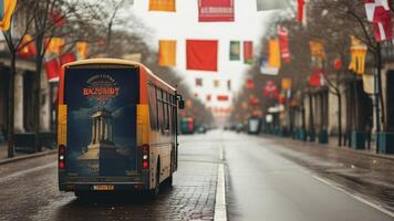 A city bus driving down a wet street decorated with flags. photo