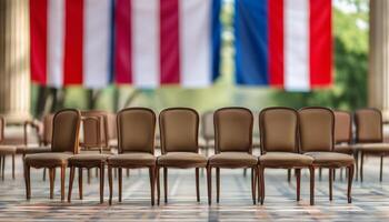 Empty chairs facing a flag backdrop photo