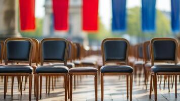 Empty chairs in a public square, French flags in background photo