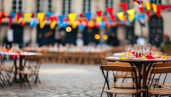Tables set for a festive outdoor party in a cobblestone square. photo