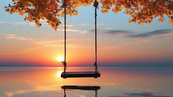 Sunset over calm water with a wooden swing photo