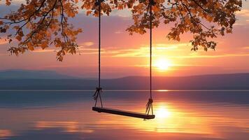 Sunset over lake with swing photo