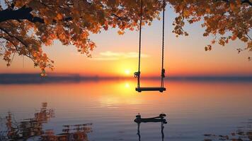 Swing at sunset over calm lake photo