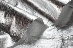Silver foil on a white surface photo