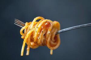A Delicious Plate of Spaghetti Noodles Twirled with a Fork, Featuring Classic Italian Flavor photo