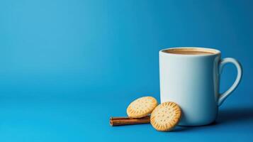 Coffee and biscuits on blue background photo