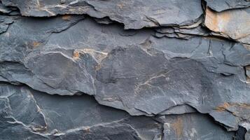 A close up of a rock wall with some cracks photo
