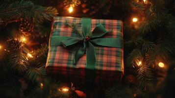 A Wrapped Gift Under a Christmas Tree With Lights photo