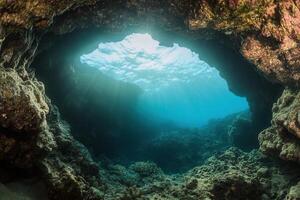 Underwater cave with sunlight filtering through. photo