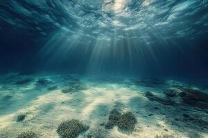 Underwater scene with rays of light and sandy seabed. photo