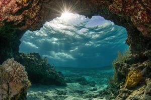 Underwater scene with sunlight filtering through coral arch. photo