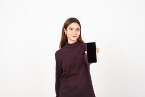 Smiling at Camera Holding Smartphone, Showing and Presenting Blank Screen for Ad Or Apps Of Beautiful Asian Woman Isolated On White Background photo