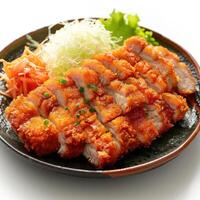 A plate of sushi containing katsu, salads, and a garnish on top. photo