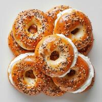 A collection of bagels fresh out of the oven, with a variety of toppings and fillings. photo