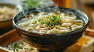 A bowl of noodles with a bowl of broth and a bowl of vegetables photo