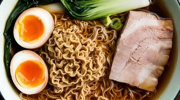 A bowl of ramen with meat, eggs and vegetables photo