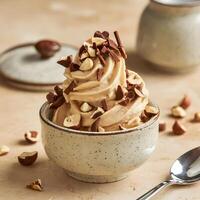 A bowl of ice cream with nuts and chocolate chips photo
