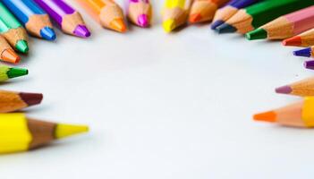 Crayons in a circle on white. A set of colored crayons is arranged in a circular formation on a white surface, showcasing vibrant hues and shades. photo