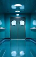 A blue hallway with two doors and a circular window. The hallway is empty and the doors are closed photo