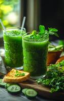 Green smoothies and healthy snacks. Two refreshing green smoothies are served alongside slices of bread and cucumbers, creating a vibrant, healthy scene. photo