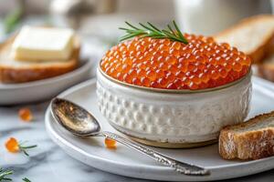 Salmon roe with bread and butter displayed on elegant table setting photo