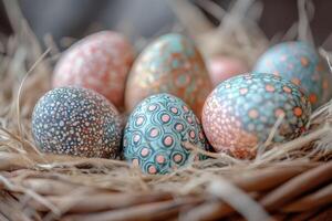 Decorated easter eggs lying in grass nest with daisies in background photo