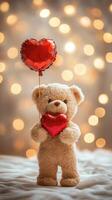 Teddy bear holding red heart balloon with bokeh lights background photo